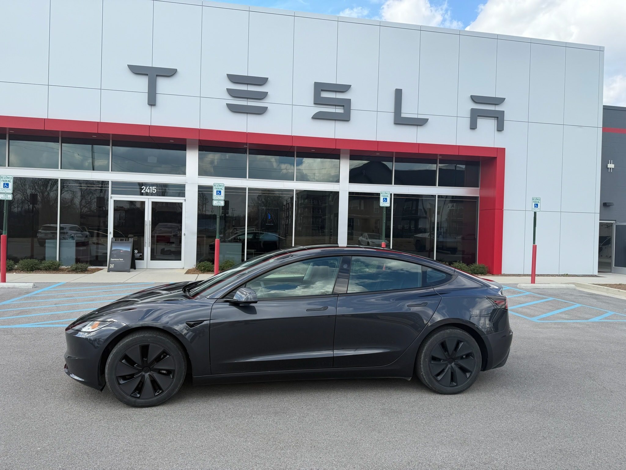 Tesla Model 3 Highland in front of service center