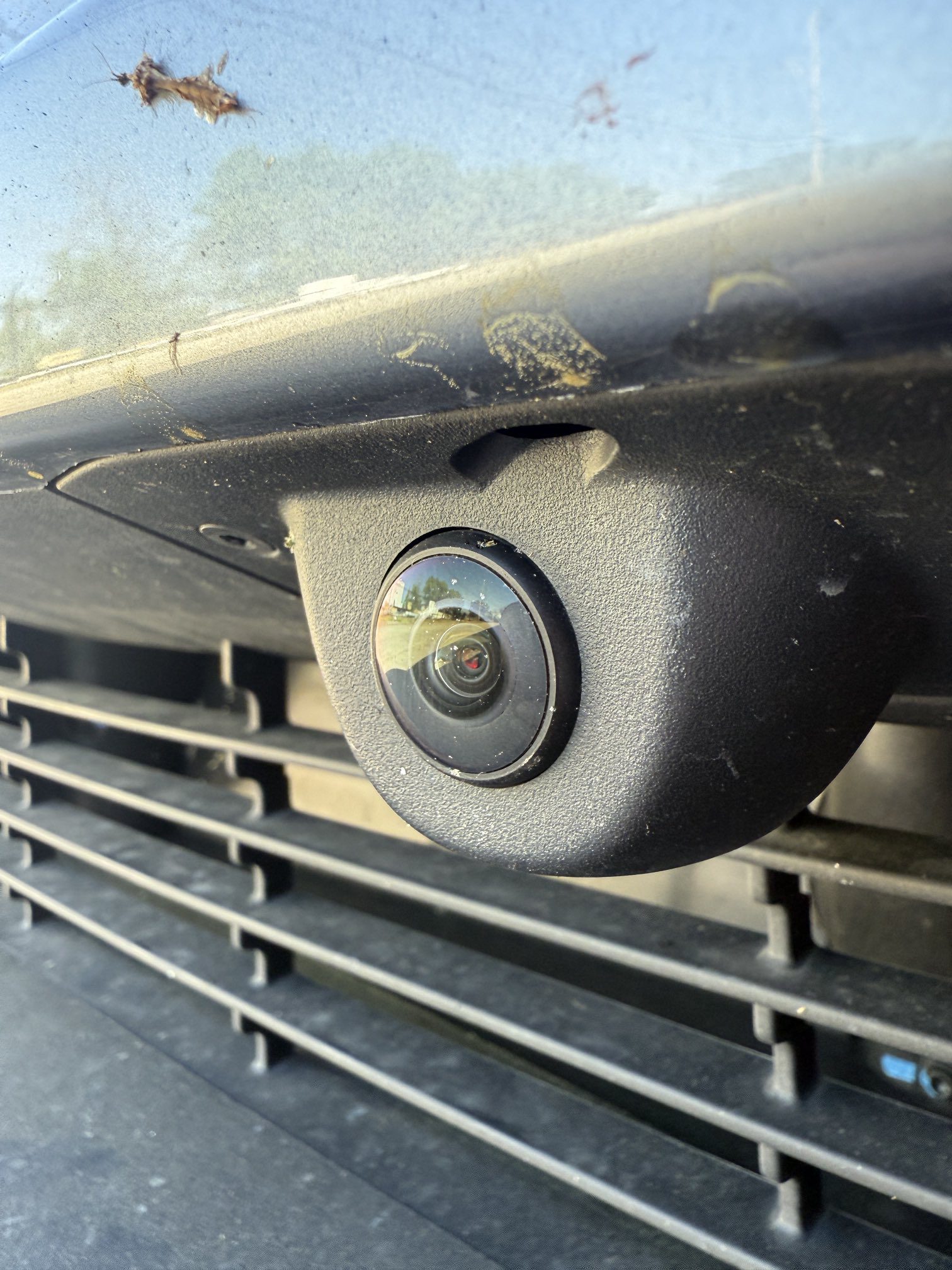 Tesla front camera takes a lot of abuse from rock chips and road debris